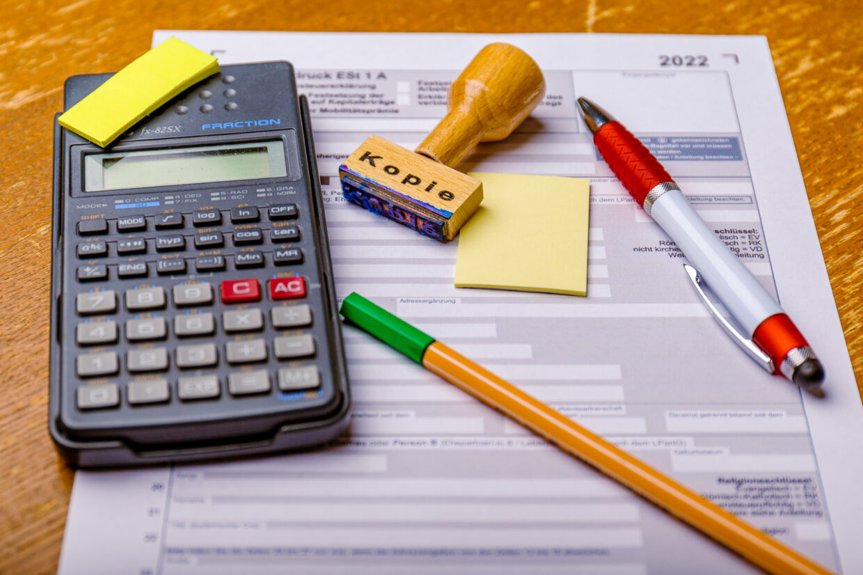 Steuererklärung, Taschenrechner, Stift und Stempel